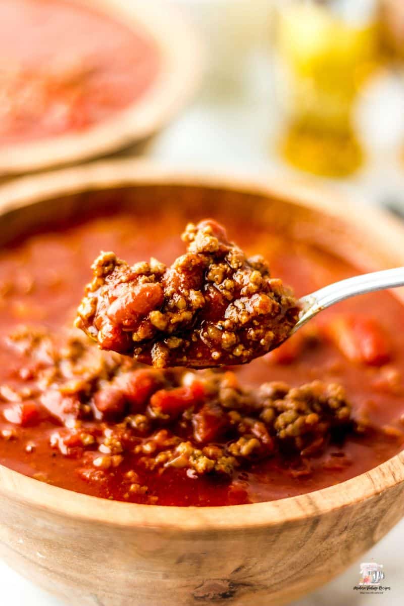 Up close picture of a spoonful of chili with ground beef