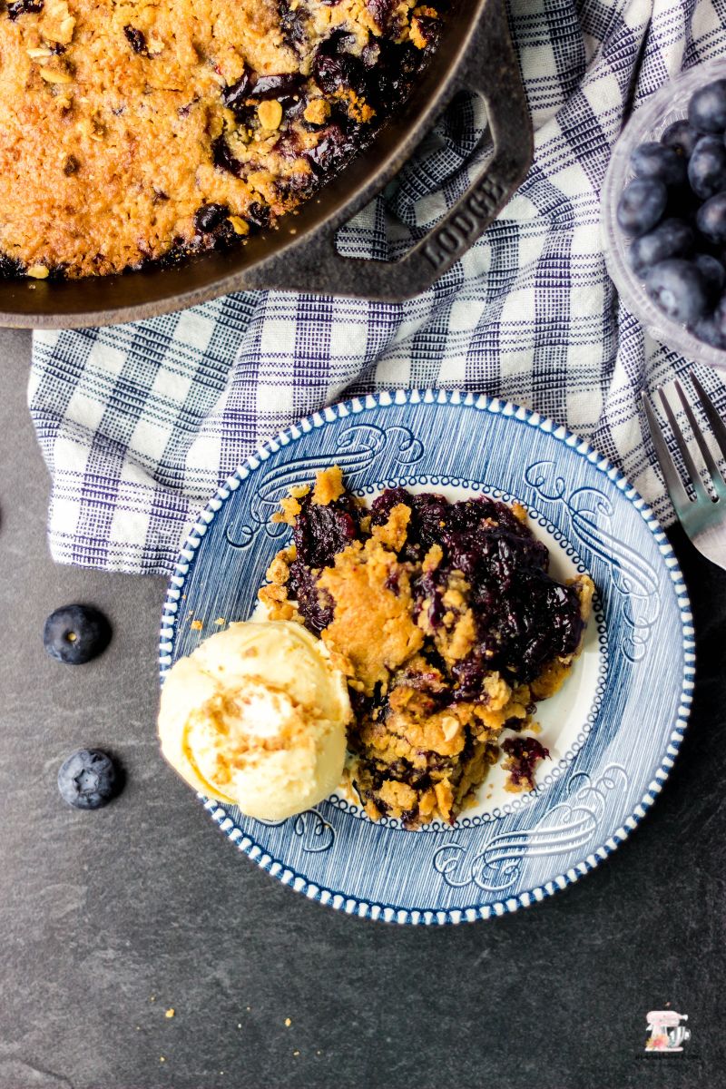 Blueberries topped with a crumble in a cast iron skillet