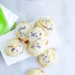 Butter shortbread cookies stacked on top of each, covered in glaze and lavender.