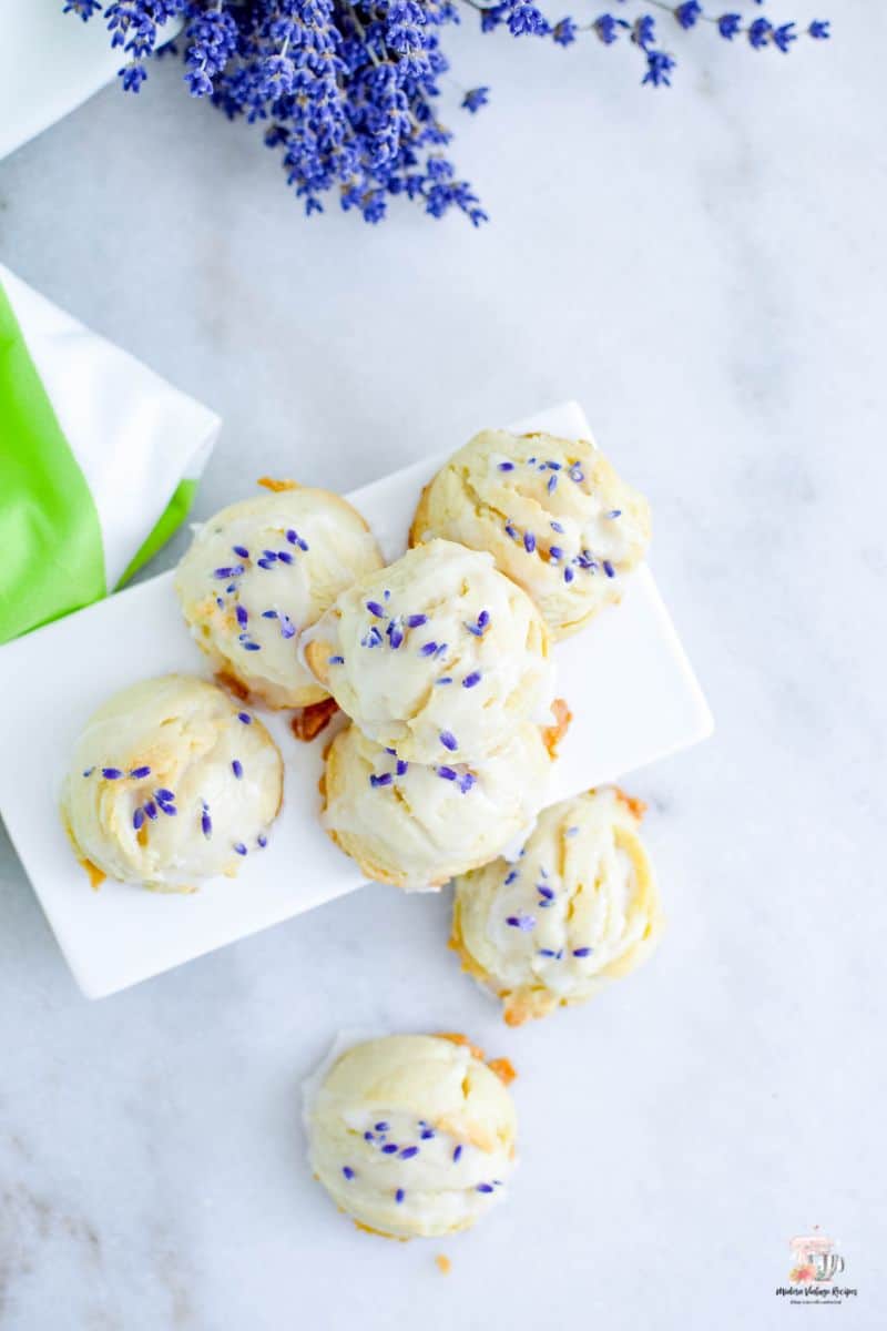 Shortbread cookies topped with a glaze and fresh lavender. 